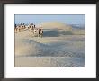 Men Traveling On Camelback Across Sand Dunes, Jaisalmer, Rajasthan, India by Philip Kramer Limited Edition Print