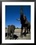 A Juvenile Elephant Stands Next To An Adult That Has Its Trunk Upraised by Beverly Joubert Limited Edition Print