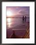 Couple Walking Along Beach At Sunset, Nassau, Bahamas, Caribbean by Greg Johnston Limited Edition Print