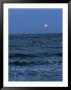 A Twilight Shot Of Waves Coming Into Shore With The Moon In The Background by Ira Block Limited Edition Print