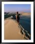 Woman Walking Towards Car On Sand Dune Ridge, Khor Al-Adaid, Qatar by Mark Daffey Limited Edition Print