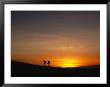 Expedition Members Hike Into Base Camp Silhouetted Against A High-Altitude Sunset by Stephen Alvarez Limited Edition Print