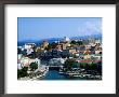 Town Buildings And Lake Voulismeni With Ocean In Distance, Agios Nikolaos, Greece by John Elk Iii Limited Edition Pricing Art Print