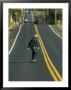 Man Longboarding Down Road, Dunedin, New Zealand by Christian Aslund Limited Edition Print