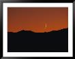 A Crescent Moon Sets Over Mountains Rimming The Western Edge Of Lake Tahoe by George F. Mobley Limited Edition Print
