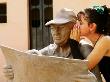 Girl In Quincinera (15Th) Birthday Dress Whispering To Statue, Plaza Del Carmen, Camaguey, Cuba by Christopher P Baker Limited Edition Print