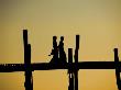 Two Women Walking Across The Ubein Bridge In Mandalay, Burma At Sunset by Scott Stulberg Limited Edition Print