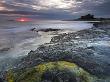 First Glow Of Sunrise Over The Sea Beside Bamburgh Castle, Bamburgh, England, Uk by Adam Burton Limited Edition Print