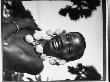 Congolese Native Girl Wearing Necklace Of Photographer's Flashbulbs Strung Together, Belgian Congo by Nat Farbman Limited Edition Print