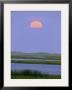 Moonrise Over A Wetland With Gentle Rolling Hills In Distance by Michael Melford Limited Edition Print
