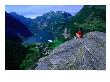 Man Resting On Rock Watching Cruise Ship Sail Out Of Geirangerfjord, Geiranger, Norway by Anders Blomqvist Limited Edition Print