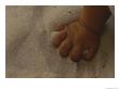 A Childs Hand Grasps A Fistfull Of White Sand by Raul Touzon Limited Edition Print