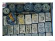 A Tray Full Of War Memorabilia Engraved Zippo Lighters, Dog Tags, Bullets, And Ancient Coins by Steve Raymer Limited Edition Pricing Art Print