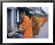 Novice Buddhist Monks Collecting Alms Of Rice, Luang Prabang, Laos, Indochina, Southeast Asia, Asia by Upperhall Ltd Limited Edition Print