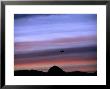 Aircraft And Mountains Silhouetted Against A Dramatic Sky At Dusk, Wyoming by Joel Sartore Limited Edition Pricing Art Print