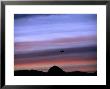 Aircraft And Mountains Silhouetted Against A Dramatic Sky At Dusk, Wyoming by Joel Sartore Limited Edition Print
