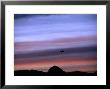 Aircraft And Mountains Silhouetted Against A Dramatic Sky At Dusk, Wyoming by Joel Sartore Limited Edition Print