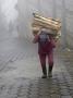 Man Carrying Load Of Firewood Up Steep Stone Street, Zunil, Guatemala by Dennis Kirkland Limited Edition Print