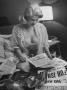 Actress Jane Mansfield Looks Over Newspapers With Her Pet Chihuahua Dog In Her Lap by Peter Stackpole Limited Edition Print