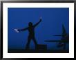 A Ground Control Person Guides A Plane On An Aircraft Carrier by Bill Curtsinger Limited Edition Print
