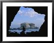 A Man Silhouetted Against La Portada Rock Arch On The Coast Of Chile by Joel Sartore Limited Edition Print