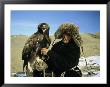 A Kazakh Eagle Hunter Poses With His Eagle On A Plain In Kazakhstan by Ed George Limited Edition Print