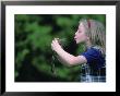 A Young Girl Plays Out A Fairy Tale As She Prepares To Kiss A Frog by Joel Sartore Limited Edition Print
