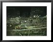 An Elevated View Of Ground Zeros Devastation At Night; Crews, Their Vehicles, And Other Equipment by Ira Block Limited Edition Print