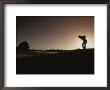 A Man Plays A Game Of Golf At Twilight by Tino Soriano Limited Edition Pricing Art Print