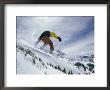 A Snowboarder Grabs The Back Edge Of His Board As He Goes Airborne by Paul Chesley Limited Edition Pricing Art Print