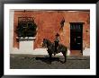 Man On Horse In Front Of A Typical Painted Wall, Antigua, Guatemala, Central America by Upperhall Limited Edition Print