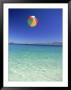 Beach Ball In Air Over Water At Beach by David Porter Limited Edition Print