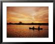 A Couple Rowing A Canoe Is Silhouetted Against A Gorgeous Sunset by Barry Tessman Limited Edition Pricing Art Print