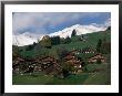 Wooden Chalets On Slope With Snow-Capped Peaks In The Background, Rougemont, Switzerland by Martin Moos Limited Edition Print