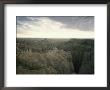 A Storm Moves Over Sheep Mountain Table In Badlands National Park by Annie Griffiths Belt Limited Edition Print