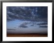 A Dramatic Landscape Shows The Flatness Of The African Plains by Chris Johns Limited Edition Print