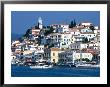 Waterfront And Town Behind Poros Harbour, Poros Town, Greece by Mark Daffey Limited Edition Print