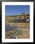 Whitby Church, Sandy Beach And Lobster Pots On Quayside, Whitby, Yorkshire, England by Neale Clarke Limited Edition Print