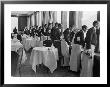 Waiters In The Grand Hotel Dining Room Lined Up At Window Watching Sonja Henie Ice Skating Outside by Alfred Eisenstaedt Limited Edition Print