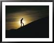 Silhouette Of A Man Walking Up A Dune Against A Cloudy Sun by George F. Mobley Limited Edition Print