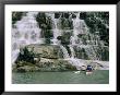 A Woman Paddles Her Kayak Next To A Waterfall by Bill Hatcher Limited Edition Print