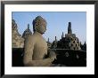Buddha Image Sitting In Open Chamber With Stupas In Background, Borobudur Temple, Indonesia by Jane Sweeney Limited Edition Print
