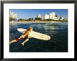A Surfer Jumps Into The Sea With The Golden Mile In The Background, Kwazulu-Natal, South Africa by Roger De La Harpe Limited Edition Pricing Art Print