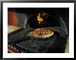 Pizza Comes Out Of A Brick Oven In A Restaurant In Rome, Italy by Richard Nowitz Limited Edition Print