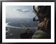 Machine Gunner Scanning For Hostiles While His Helicopter Is On Patrol Over The Mekong Delta by Larry Burrows Limited Edition Print