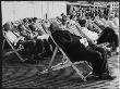 Holidaymakers Snooze In Deck Chairs On The Sea Front At Brighton, West Sussex, England by Henry Grant Limited Edition Print