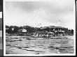 A Crew Team Rowing By Wooden Buildings On The Harlem River, As Taken From Another Boat by Wallace G. Levison Limited Edition Print