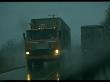Tractor Trailer Trucks Passing On Highway In Foggy Rain, Dangerous Road Conditions by Ralph Crane Limited Edition Print
