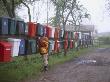 A Boy Checking For Mail In On Of Many Mailboxes Hanging On A Fence by Helena Bergengren Limited Edition Pricing Art Print