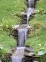 Water Feature: Water Cascades Through Meadow With Primula Pulverulenta And Carex Morrowii, Wyevale by Clive Nichols Limited Edition Print